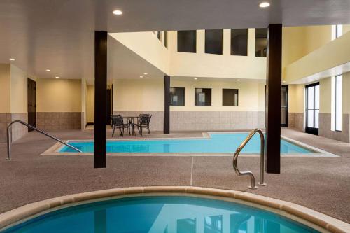 a pool in a building with two swimming pools at Days Inn by Wyndham Carbondale in Carbondale