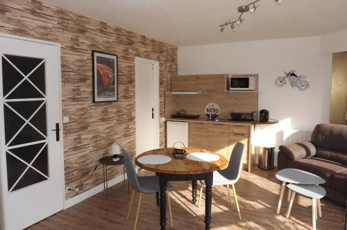 un salon avec une table, des chaises et un canapé dans l'établissement briand, à Charleville-Mézières