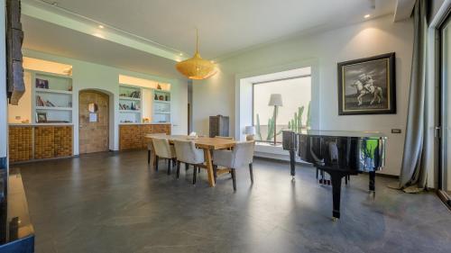 a dining room with a table and a television at Villa Maria, Luxury Marrakech in Marrakesh