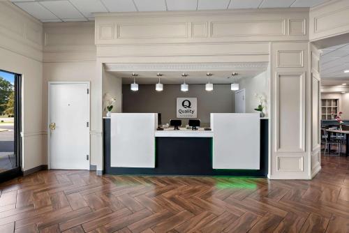 a lobby with a reception desk in a building at Quality Inn & Suites Fayetteville I-95 in Fayetteville