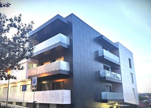 a building with balconies on the side of it at Guimarães City Center by LuxiStay in Guimarães