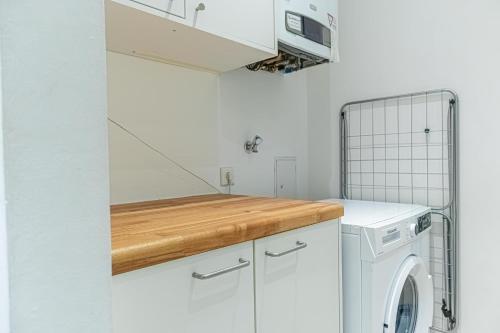 a white laundry room with a washer and dryer at Elegant 2BR Apt.@Wiener Stadthalle/Central Located in Vienna