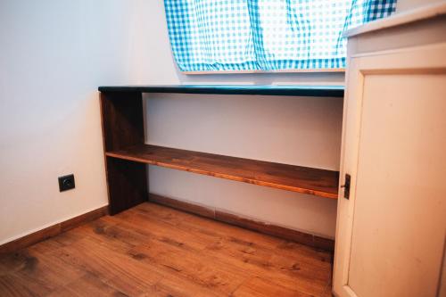 a closet with a wooden shelf in a room at Podklášterský domek in Třebíč