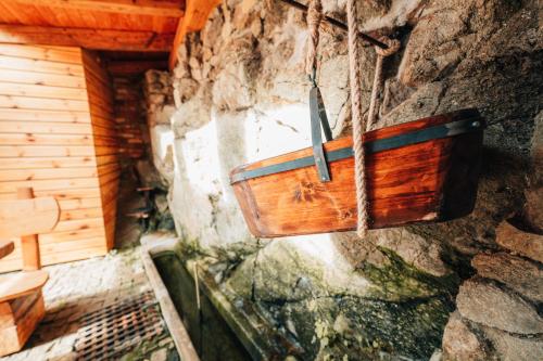 a wooden box hanging from a stone wall at Podklášterský domek in Třebíč