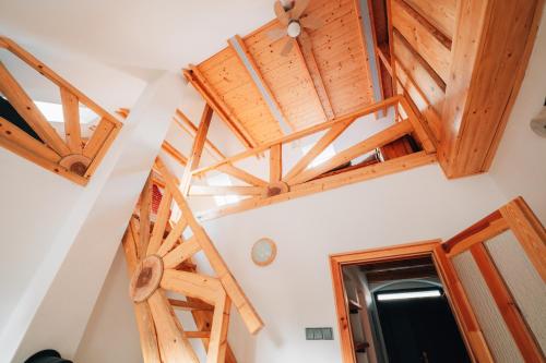 a staircase in a room with wooden ceilings at Podklášterský domek in Třebíč