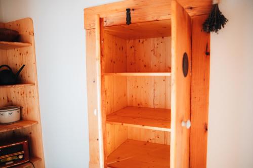 a wooden book shelf in a room at Podklášterský domek in Třebíč