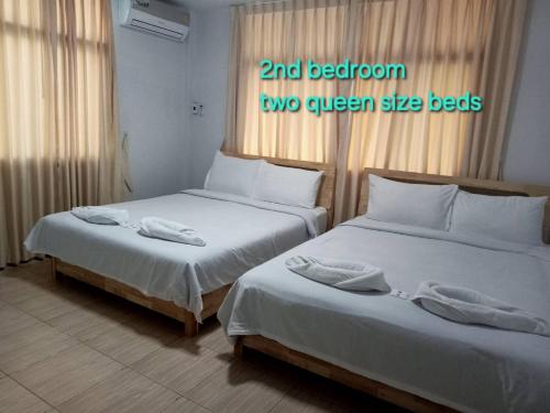 two beds in a room with two queen size beds at Sealife6 Beach Pool villa in Ban Nong Si Tong