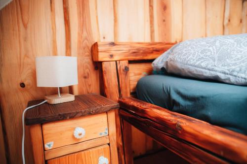 a bedroom with a bed and a lamp on a dresser at Podklášterský domek in Třebíč