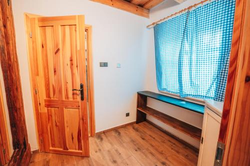 a room with a wooden door and a window at Podklášterský domek in Třebíč