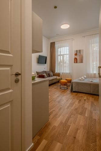 a room with a bed and a living room at Railway Apartments in Vilnius