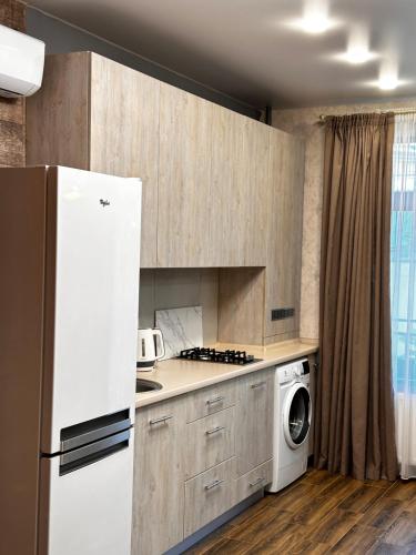 a kitchen with a refrigerator and a washing machine at Apartments Black Sea in Odesa