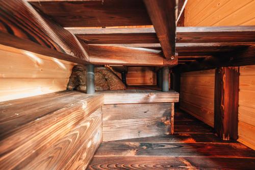 an inside view of a wooden cabin with wooden beams at Podklášterský domek in Třebíč