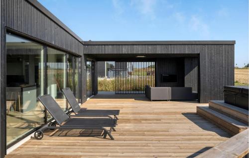 a deck with two lounge chairs on a house at Amazing Home In Børkop With Wifi in Børkop