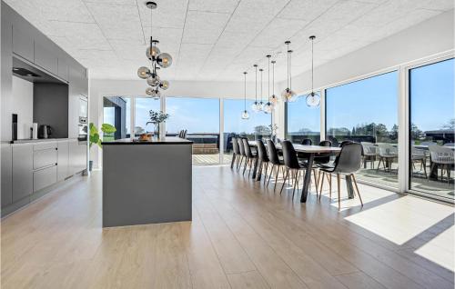 a kitchen and dining room with a table and chairs at Amazing Home In Børkop With Wifi in Børkop