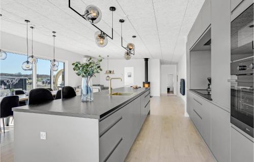 a kitchen with white cabinets and a counter with a sink at Amazing Home In Børkop With Wifi in Børkop