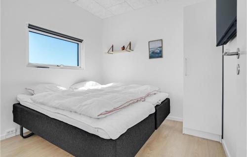 a bed in a white room with a window at Amazing Home In Børkop With Wifi in Børkop