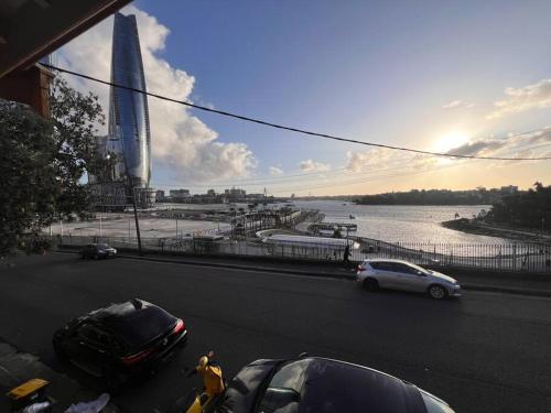 a street with cars parked on the side of the road at Golden Dream in Sydney