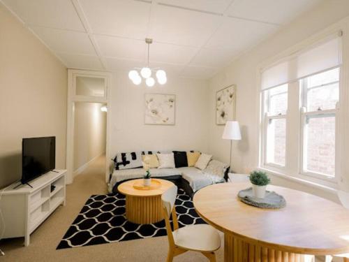 a living room with a couch and a table at Golden Dream in Sydney