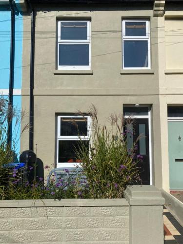 a house with windows and plants in front of it at Seaside Retreat in Broadwater
