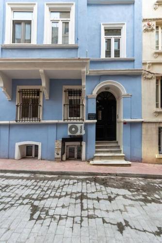 a blue building with windows and a door at Maison Chic - Newly Renovated 3Br in City Center in Istanbul