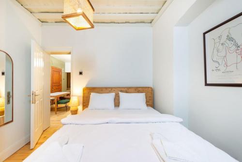 a white bedroom with a bed and a table at Maison Chic - Newly Renovated 3Br in City Center in Istanbul