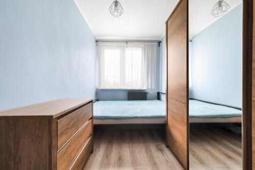 a small bedroom with a bed and a window at Simple Nook, Gdańsk Wejhera by Real Apartments in Gdańsk