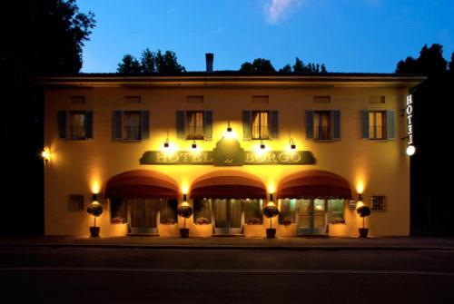 a building with a lit up facade at night at Hotel Del Borgo in Bologna