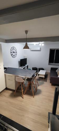 a living room with a large table and chairs at Le Duplex in Meximieux