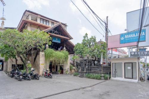 a group of motorcycles parked in front of a building at RedDoorz Plus at Mahajaya Hotel Denpasar in Denpasar