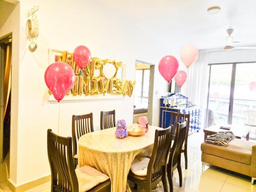 a dining room with pink balloons and a table at Mossy Forest Family Retreat II, 2-8 pax, Cameron Highlands in Cameron Highlands