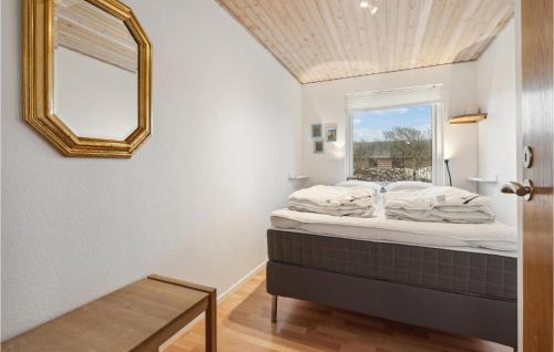 a bed in a room with a mirror and a window at 3 Bedroom Lovely Home In Vestervig in Vestervig