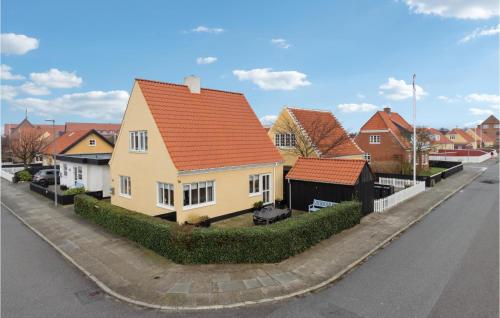 a yellow house with an orange roof on a street at 4 Bedroom Beautiful Home In Skagen in Skagen