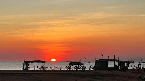a group of bikes parked on the beach at sunset at Dreamville Beach Homestay in Phu Yen