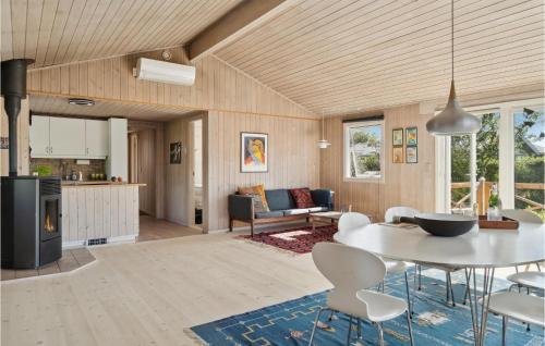 a kitchen and living room with a table and chairs at 3 Bedroom Stunning Home In Gilleleje in Gilleleje