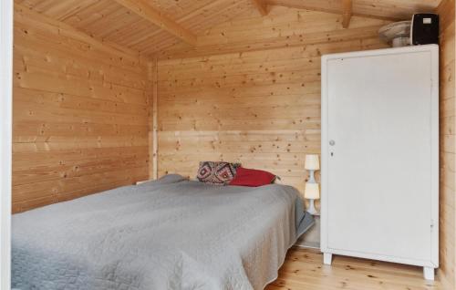 a bedroom with a bed in a wooden cabin at Cozy Home In Vig With Wifi in Vig