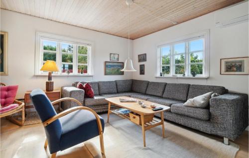 a living room with a couch and a table at 2 Bedroom Cozy Home In Allinge in Allinge