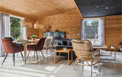 a living room with a table and chairs at Awesome Home In Væggerløse With Kitchen in Marielyst