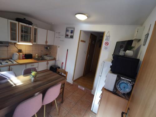 a small kitchen with a table and a clock on it at Aqualuna Petrov brlog in Podčetrtek