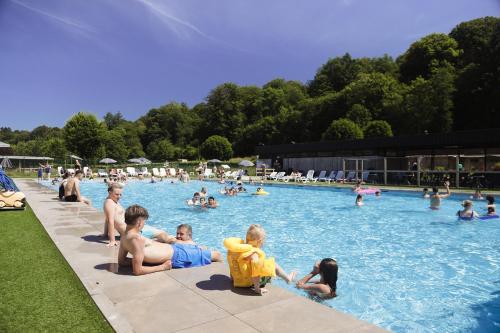a group of children sitting in a swimming pool at Camping Le Florenville in Florenville