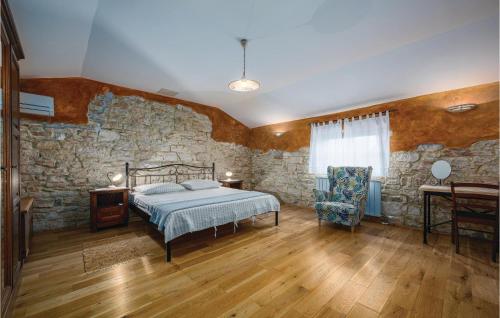 a bedroom with a bed and a stone wall at Holiday Home Butkovici Croatia in Butkovići