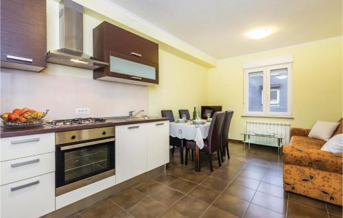 a kitchen with a table and a dining room at Nice Apartment In Calvle With Wifi in Podrvanj