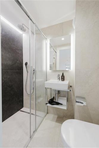 a bathroom with a sink and a shower at Appart Hotel Neostelia in Annecy