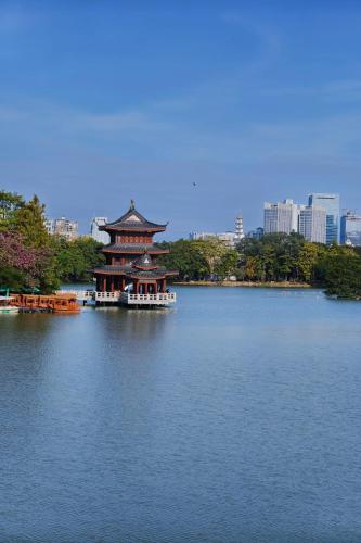 a pagoda in the middle of a large lake at iTree Guanhu Academy Huizhou West Lake in Huizhou