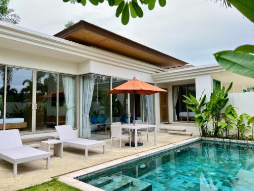an image of a villa with a swimming pool at Trichada Villas by RESAVA in Bang Tao Beach