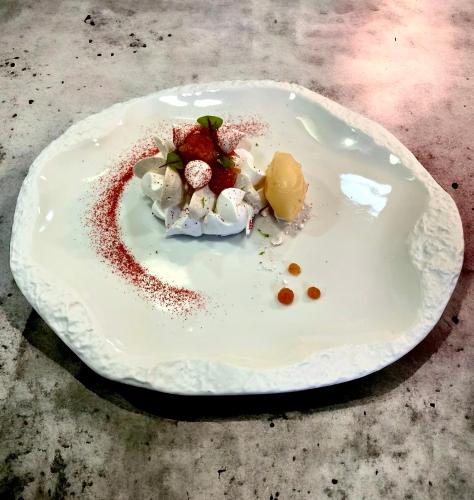 a white plate with food on it on a table at Hôtel Le Roi Théodore & Spa in Porto-Vecchio