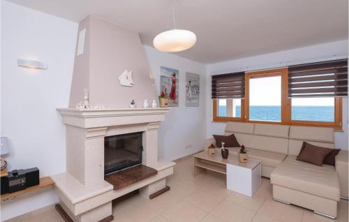 a living room with a fireplace and a couch at Nice Home In Prizba With Sauna in Prizba