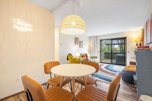 a kitchen and living room with a table and chairs at Uplake Forest Retreat in Kenmore