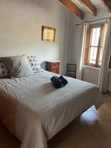 a bedroom with a large white bed and a window at Casa Es Mercat in Sóller