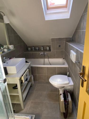 a bathroom with a sink and a tub and a toilet at Maison Marmont in Vela Luka