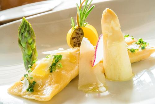 a white plate with three pieces of food on it at Hotel Englhof in Zell am Ziller